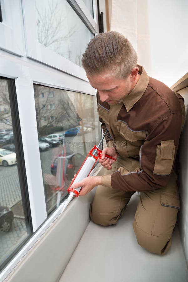 Worker Applying Glue With Silicone Gun stock photo