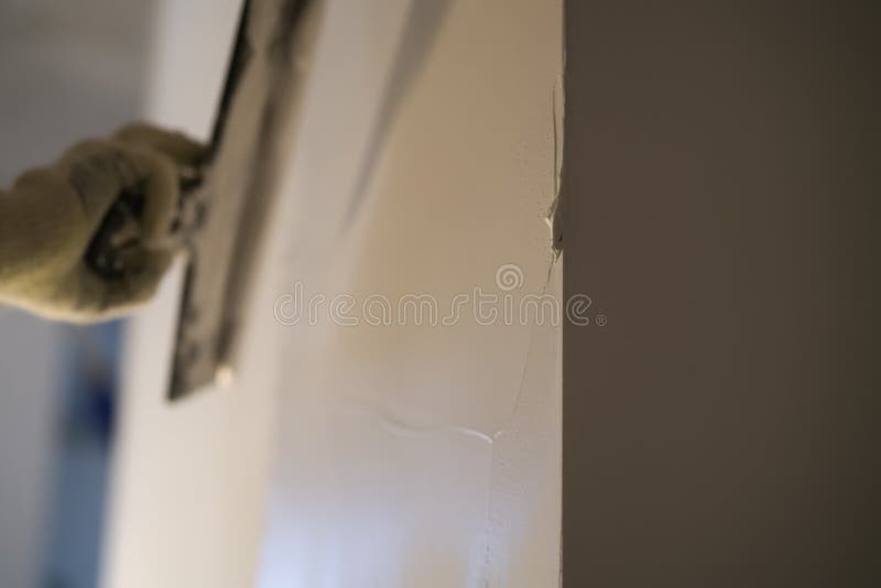 Worker Applying Putty On The Wall With Putty Knife Stock Image
