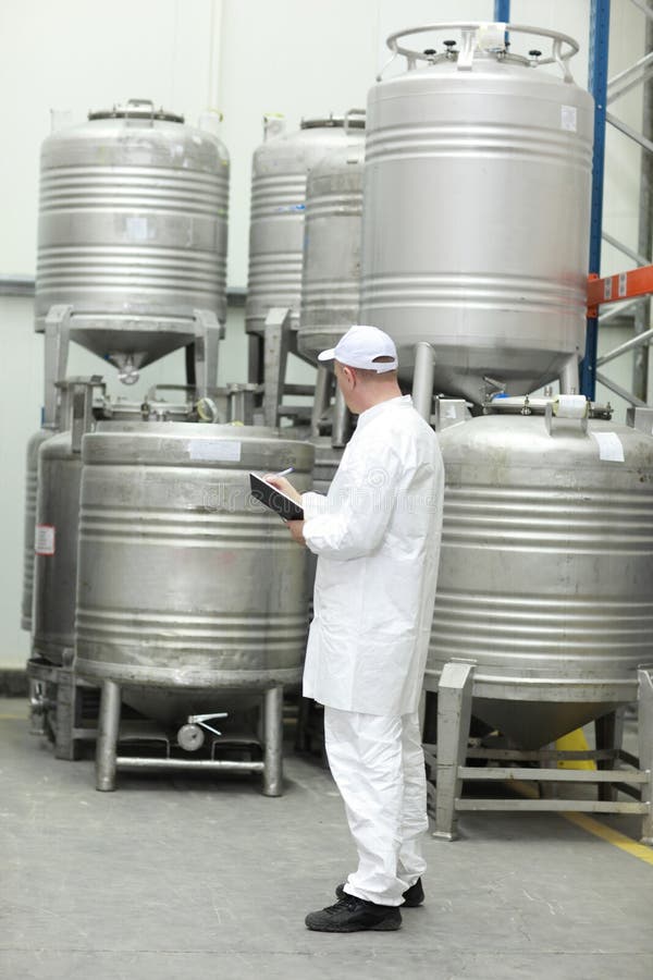 Worker checking stocks in foodstuff storehouse