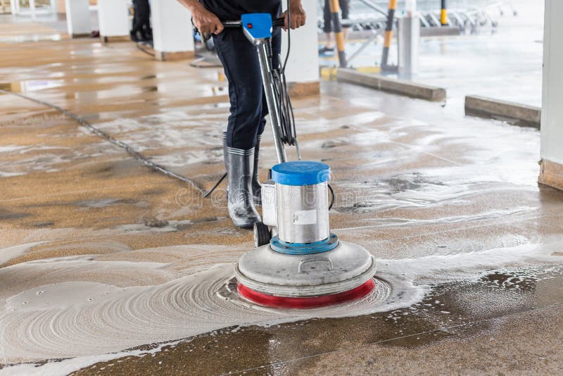 Worker cleaning sand wash exterior walkway using polishing machine and chemical or acid stock photo Worker cleaning sand wash exterior walkway using polishing machine and chemical or acid stock photo