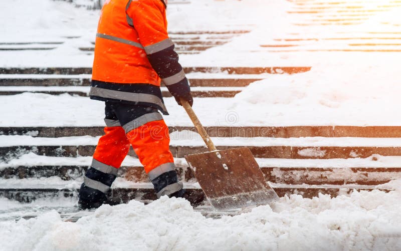 Worker Clearing Snow by Shovel after Snowfall. Outdoors Snow Removal