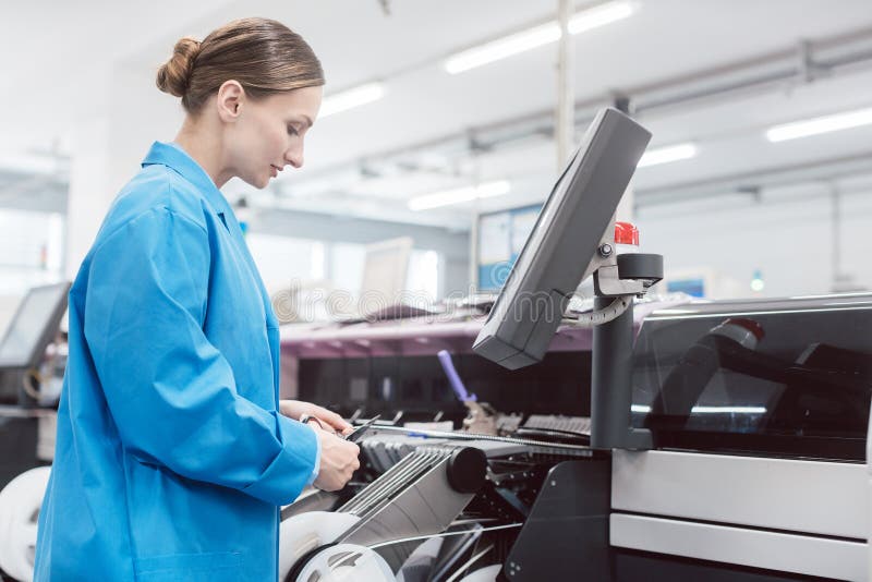 Worker confectioning electronic parts on assembly line royalty free stock photography