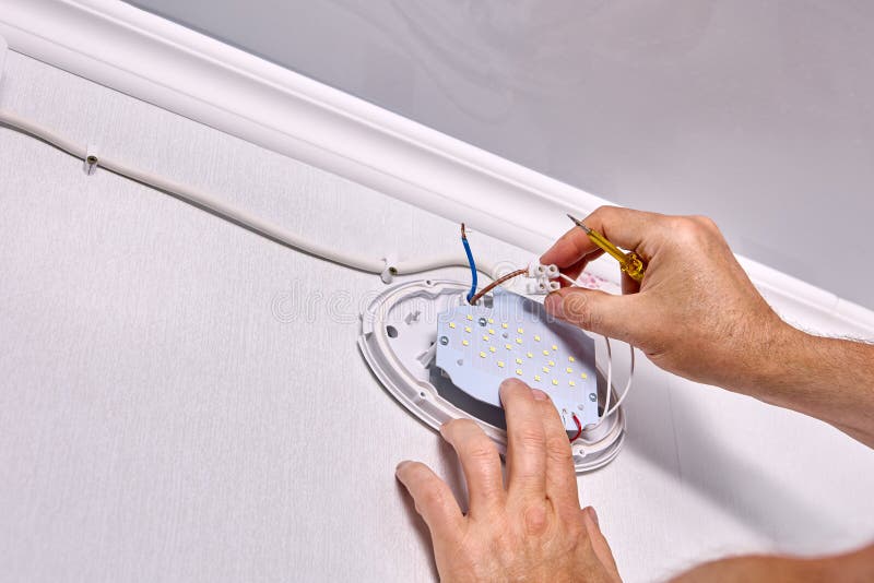 Electrician Connecting Electric Wall Fixture To Wires Stock Photos Free & RoyaltyFree Stock