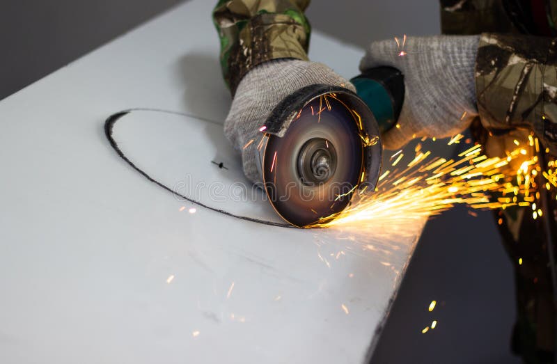 Worker Cuts a Circle in Metal with an Angle Grinder Stock Photo Image