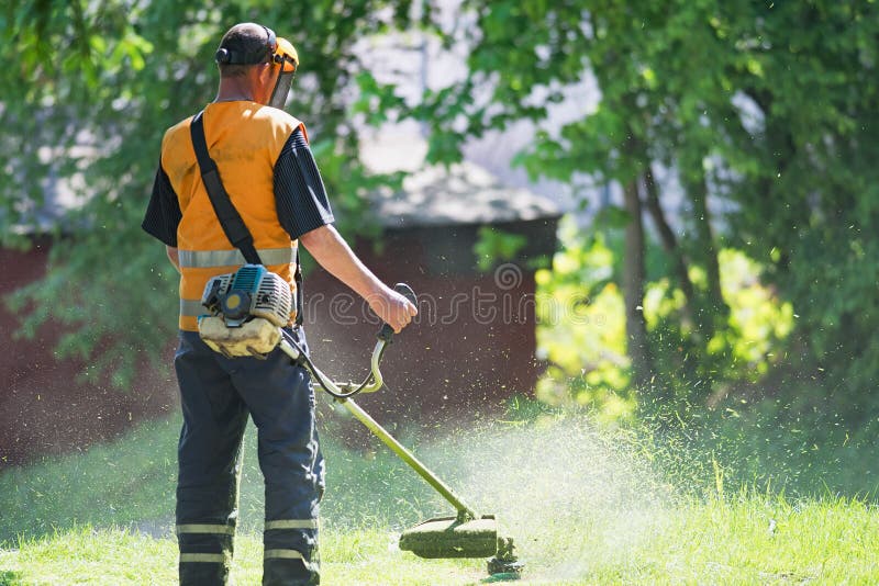 Worker Cutting Grass With A Grass Trimmer Stock Image - Image of ...