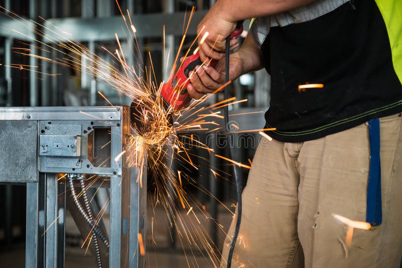 Worker Cutting Metal By Circular Saw On Construction Site Stock Image