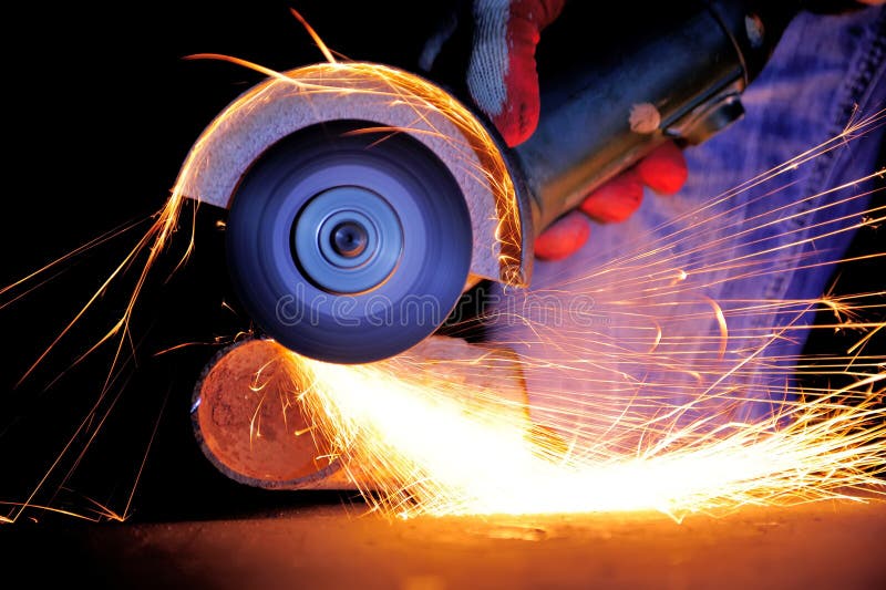 Heavy Industry Worker Cutting Steel with Angle Grinder Stock Photo