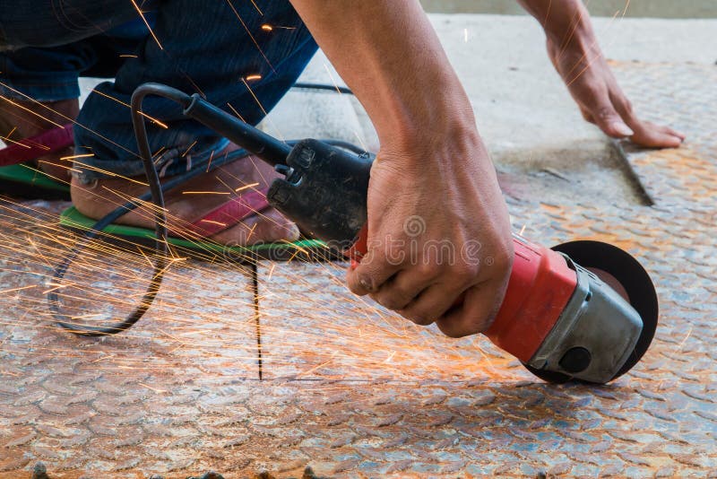 Worker cutting metal with grinder. Sparks while grinding iron royalty free stock photos Worker cutting metal with grinder. Sparks while grinding iron royalty free stock photos