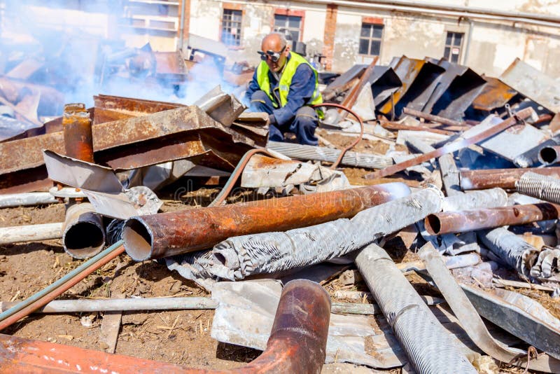 Worker is Cutting Scrap Metal with Acetylene Torch Editorial Image