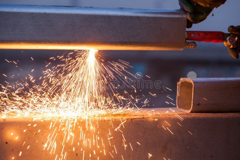 Worker Cutting Steel Pipe Using Metal Torch and Install Roadside Stock