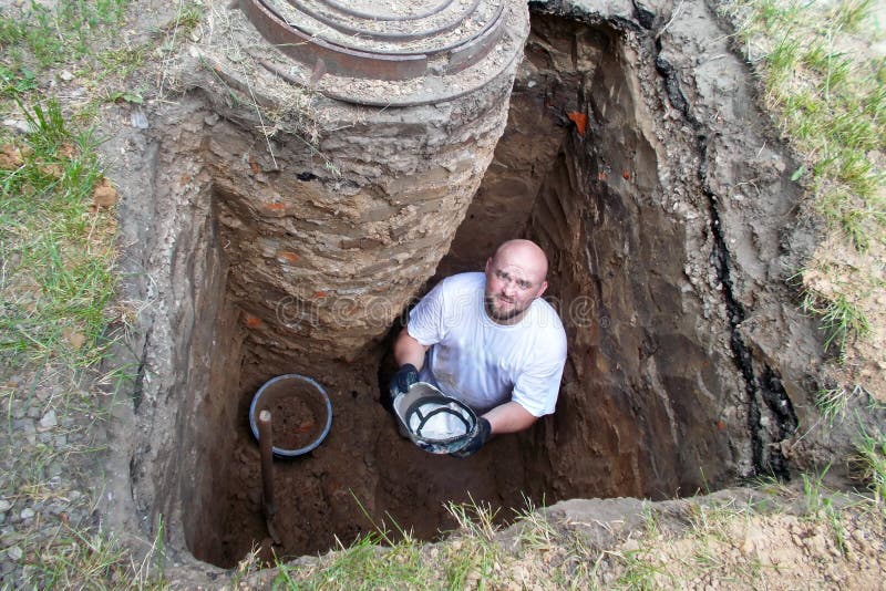 Worker in a deep hole