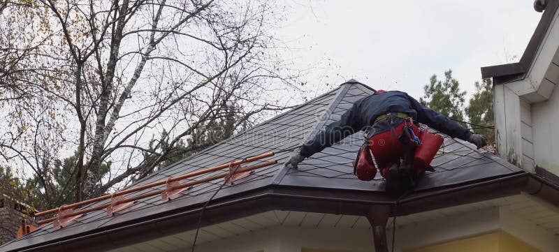 Worker Does the Installation of the Roof of House. Installation Stock ...