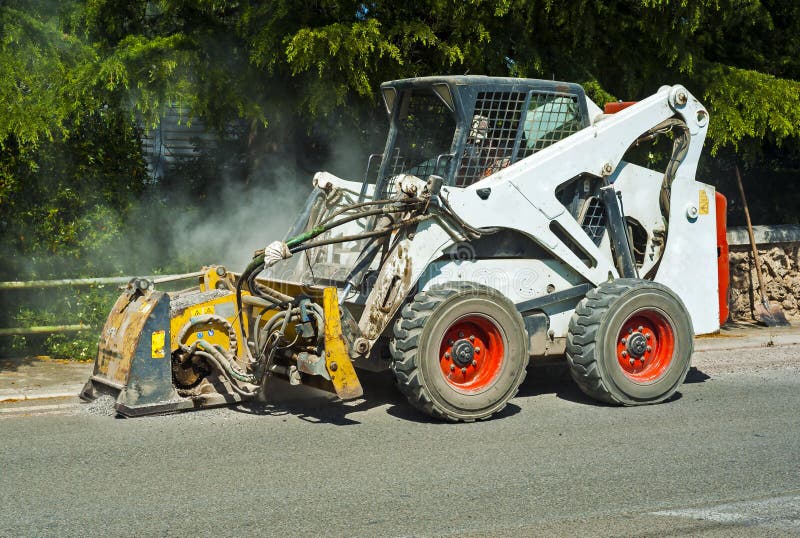 Worker driver Skid steer remove Worn Asphalt stock photos