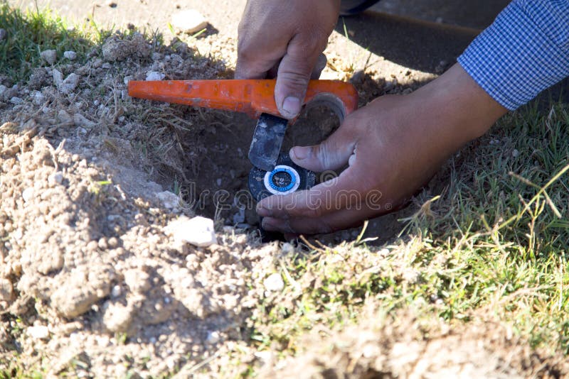 Worker fix lawn sprinkler stock image