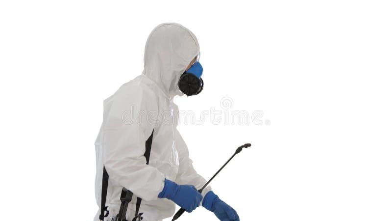 Worker in Hazmat Suit and Face Protection Mask Walking With Disinfection Equipment on white background. Medium shot. Side view. Worker in Hazmat Suit and Face stock image
