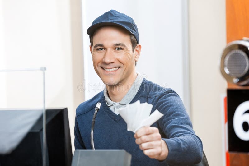 Worker Holding Tickets At Box Office royalty free stock photo