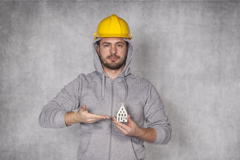 Worker holds a house in his hand royalty free stock images