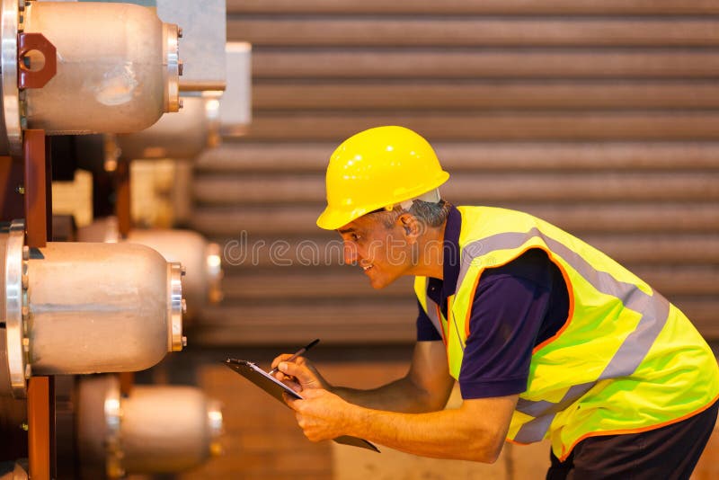 Worker inspecting machinery