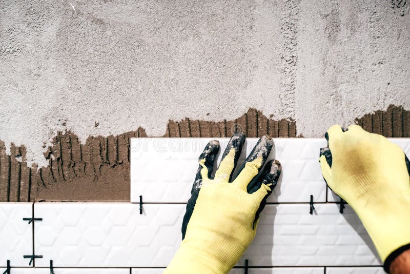 Industrial worker installing ceramic tiles. Shower area covered in ceramic tiles with strong adhesive. Bricklayer tiler stock images, royalty-free photos and pictures