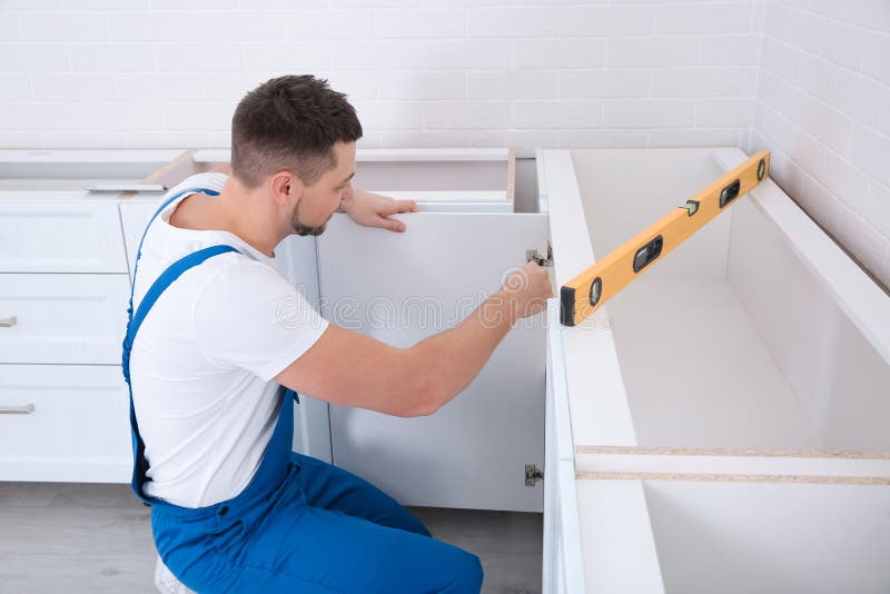 Worker Installing Door Of Cabinet Stock Photo Image Of Light