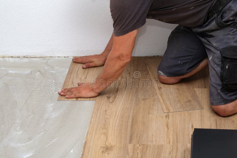 The Worker Installing New Vinyl Tile Floor Stock Image Image of