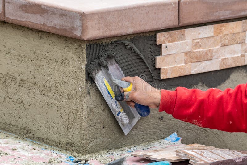 Worker Installing Wall Tile Cement with Trowel and Tile at Construction Site Stock Photo Image