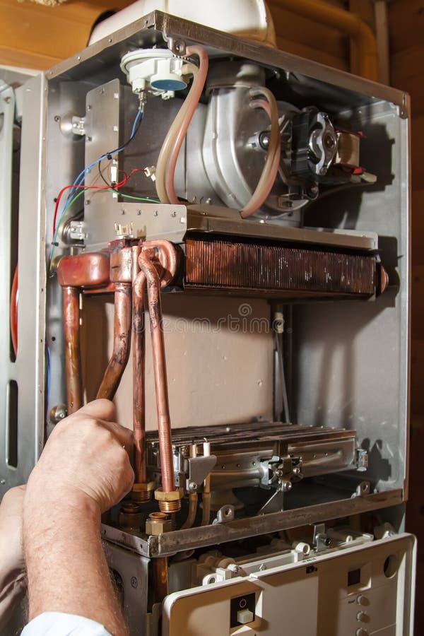 worker installs the heat exchanger after removal of a scale on a stock images worker installs the heat exchanger after removal of a scale on a stock images