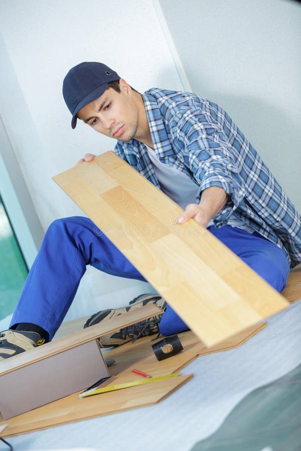 Worker with Laminate Sitting on Floor Stock Image Image of equipment