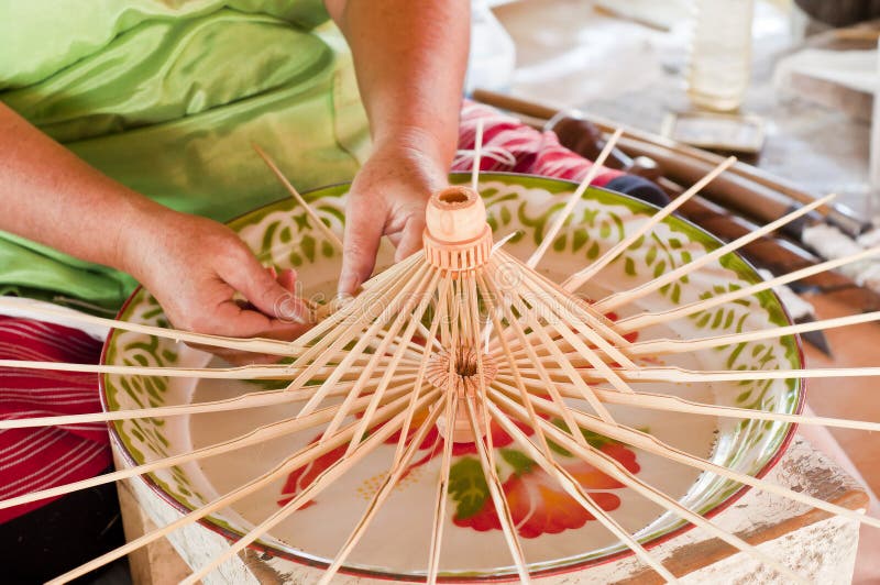 Worker making bamboo umbrella frame.