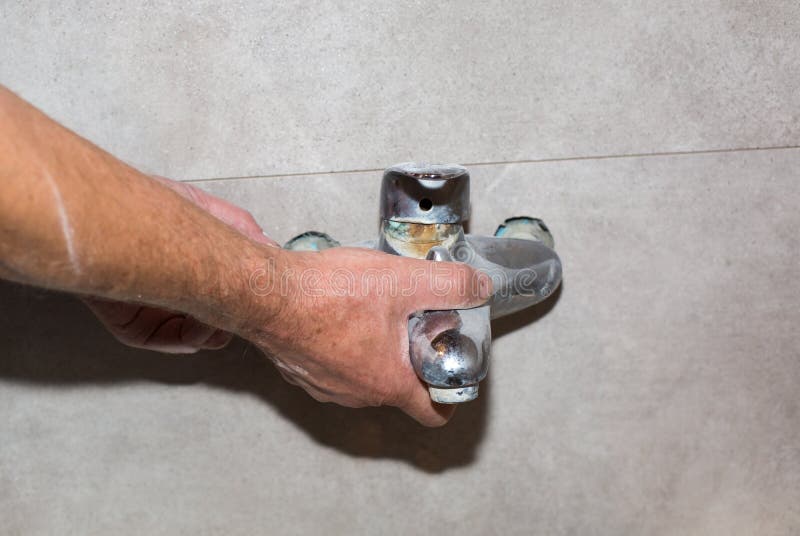 Worker is Making Bath Tap Installation. Maintenance Repair in the Flat Stock Photo Image of