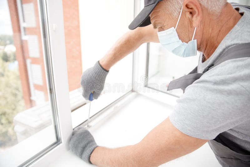 Worker Man Installs Plastic Windows and Doors with Doubleglazed White