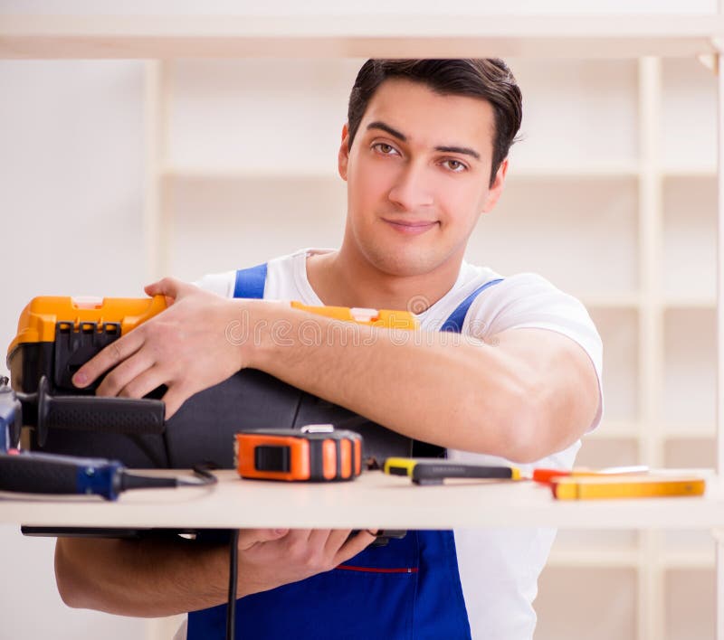 Worker man repairing assembling bookshelf stock photo