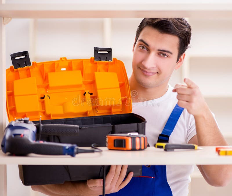 Worker man repairing assembling bookshelf stock images