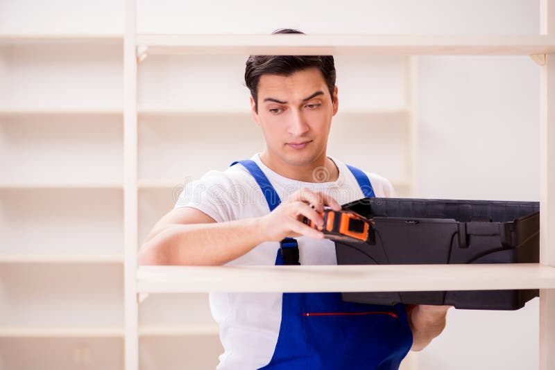 The worker man repairing assembling bookshelf stock images