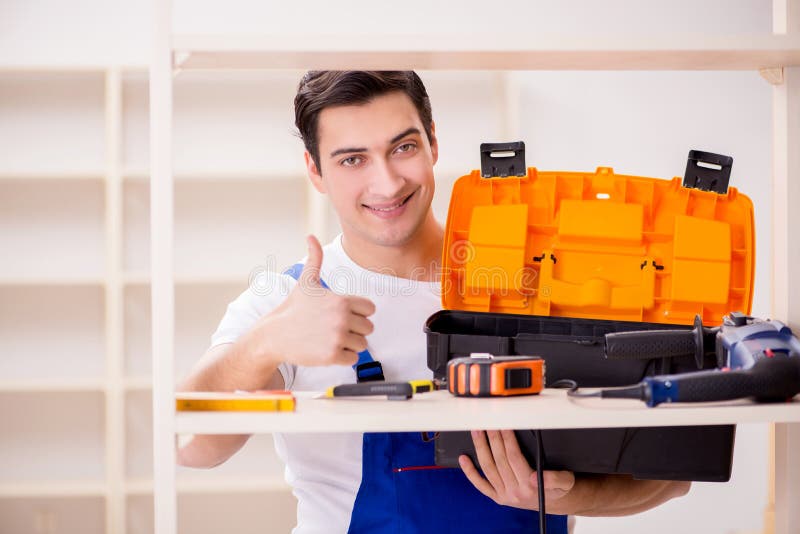 The worker man repairing assembling bookshelf stock photography