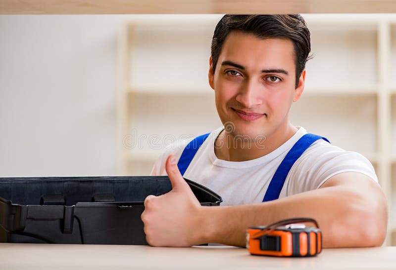 Worker man repairing assembling bookshelf stock photography