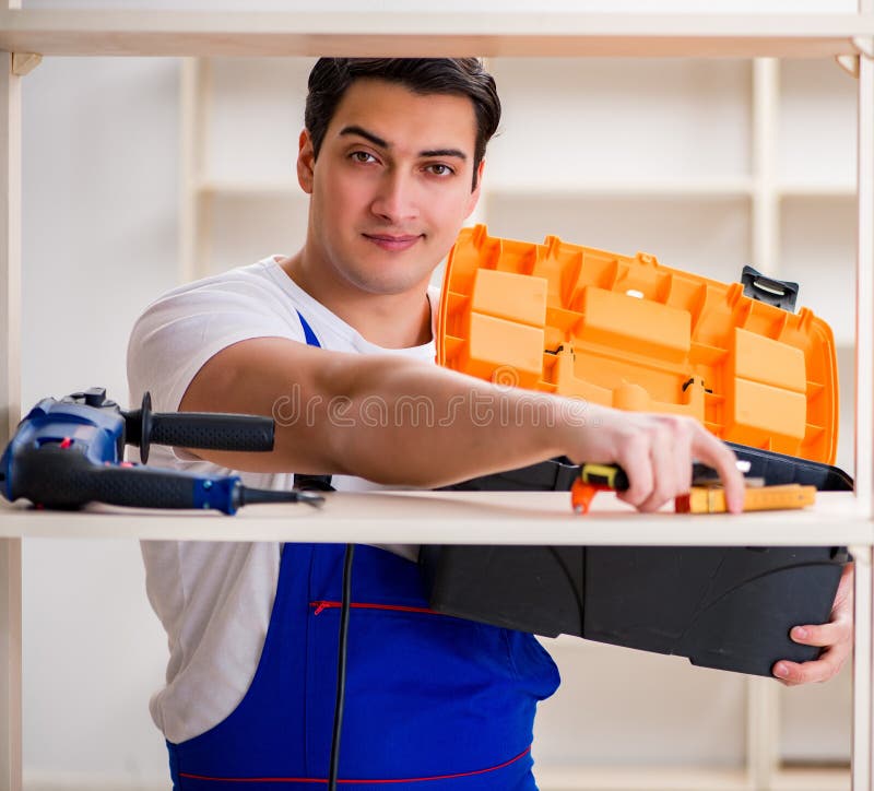 Worker man repairing assembling bookshelf stock photo