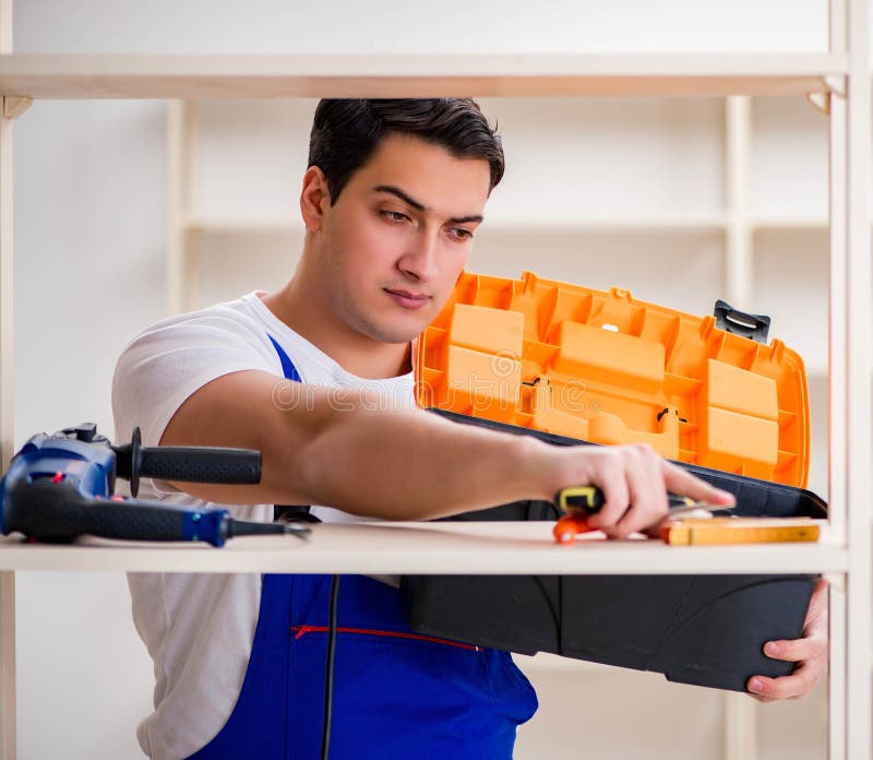 Worker man repairing assembling bookshelf stock photo