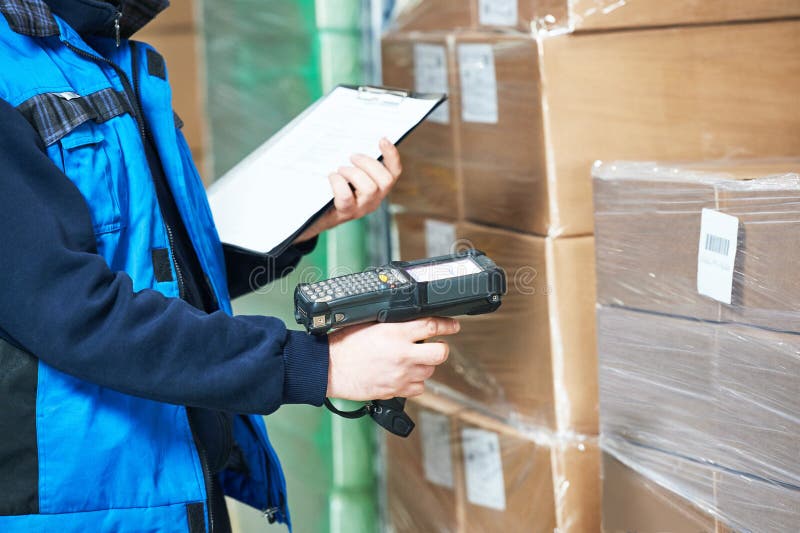 Worker man scanning package in warehouse stock images