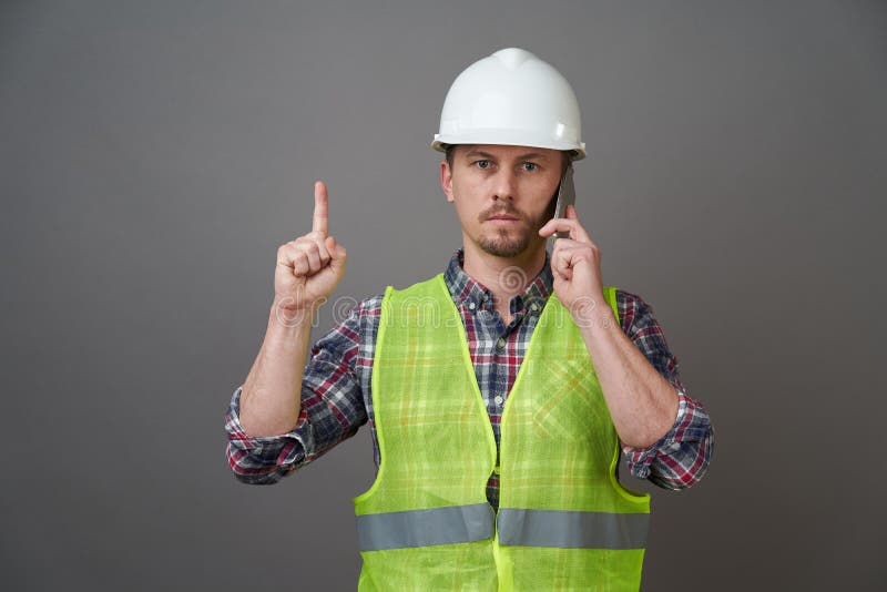 Worker Man Wearing Protective Hard Hat and Reflective Vest Stock Photo