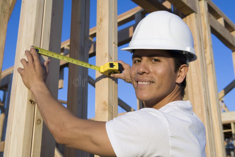 Worker Measuring Wooden Beams royalty free stock photo
