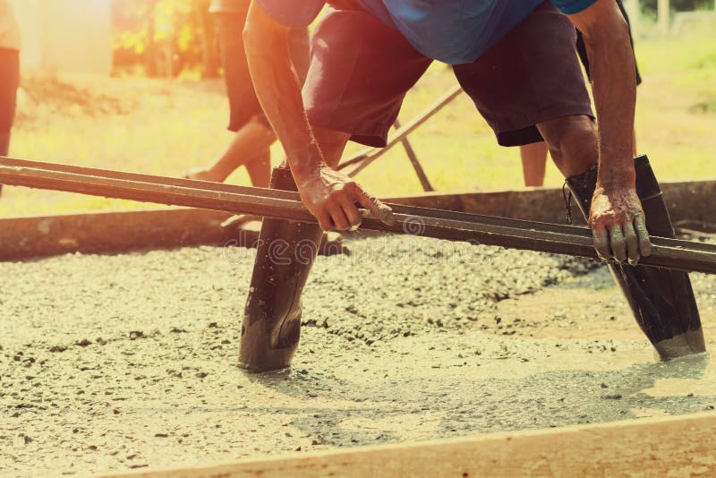 Pouring Concrete With Worker Mix Cement For Building Road At Con Stock