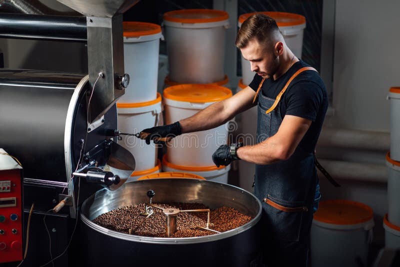 A Worker Near Coffee Roasting Equipment Will Check Time for Testing the
