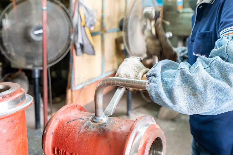 Worker or Operator Cleaning Welding Seam Remove by Knock with Hammer