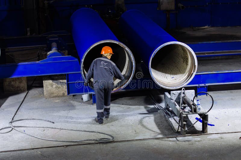 Worker painting new cast iron pipes stock photos