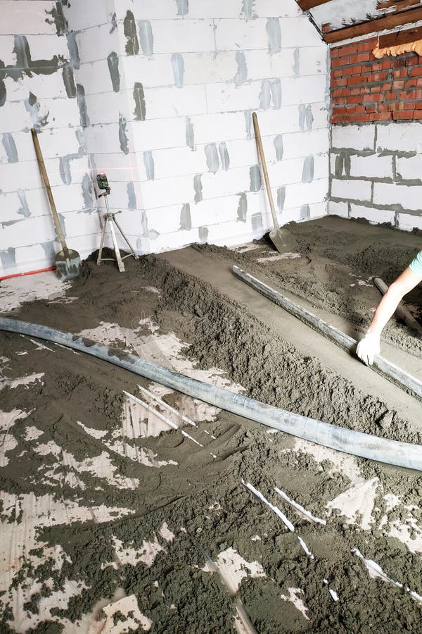 The Worker Performs A Sand Cement Floor Screed Above The Floor