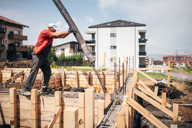 Worker pouring concrete details - concrete pouring during foundation building of house