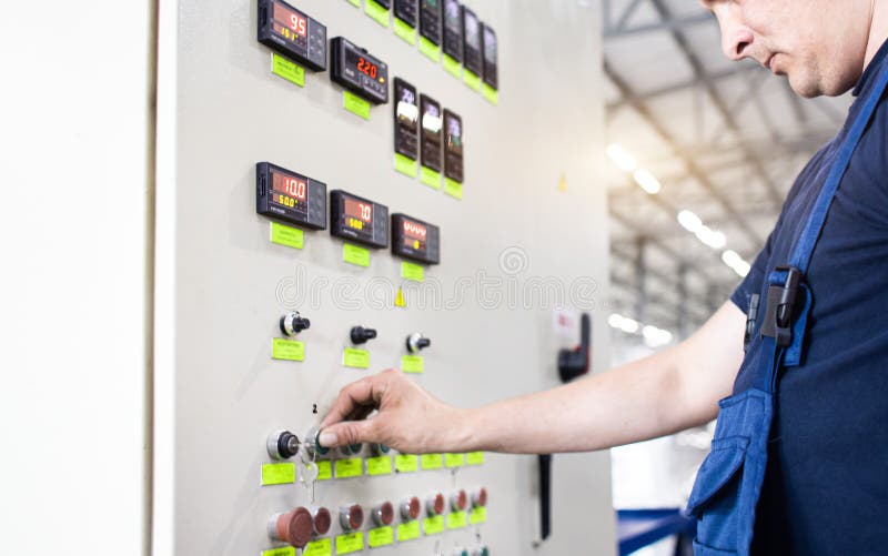 A Worker Presses a Button and Starts an Automatic Manufacturing Process