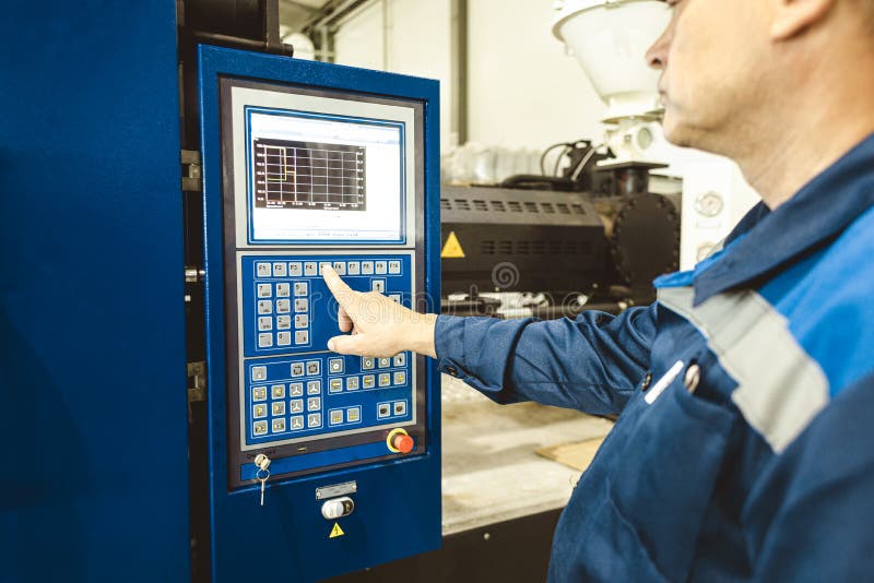 A Worker Presses a Button and Starts an Automatic Manufacturing Process