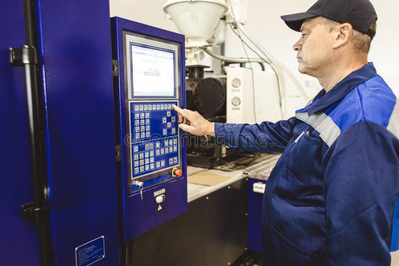 A Worker Presses a Button and Starts an Automatic Manufacturing Process